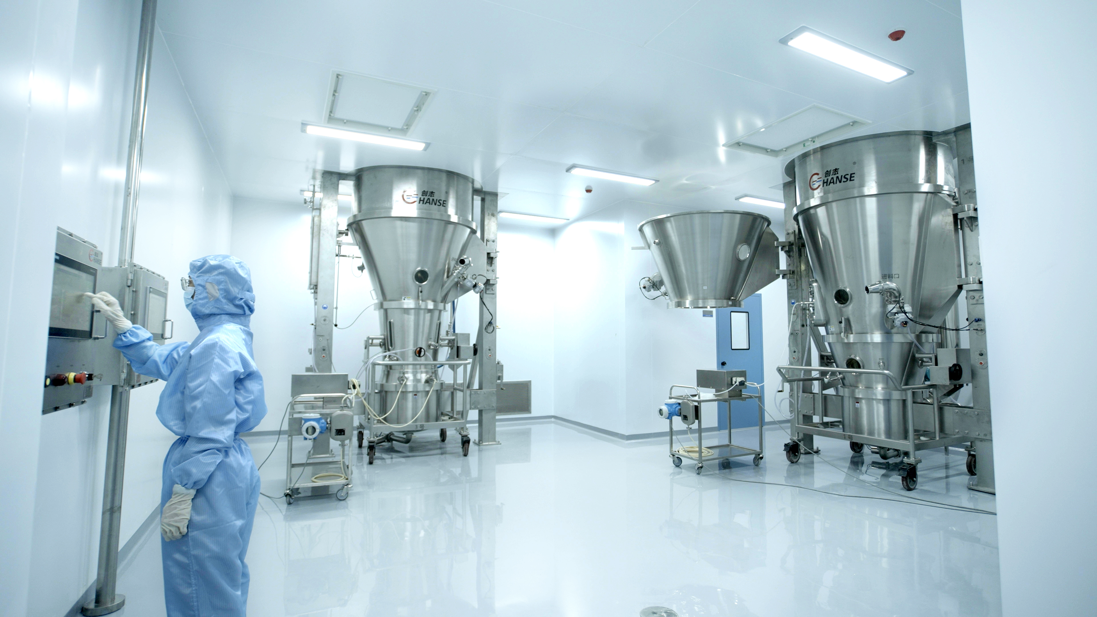 Masked operator at Apichope oral solid production equipment